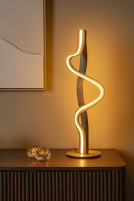 Lambada 60cm Champán De Lucide - Lambada es una elegante l&aacute;mpara de mesa met&aacute;lica con un exclusivo acabado color champ&aacute;n y una forma suave y org&aacute;nica que llama la atenci&oacute;n al instante.