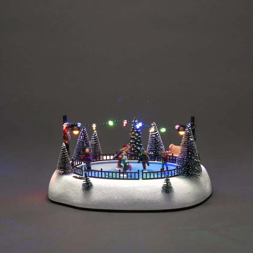 Decoración Navideña Mecánica Con Pista De Patinaje 13cm Multicolor De Konstsmide - Animada pista de patinaje sobre hielo con figuras giratorias, 12 luces LED de colores y m&uacute;sica navide&ntilde;a atmosf&eacute;rica.