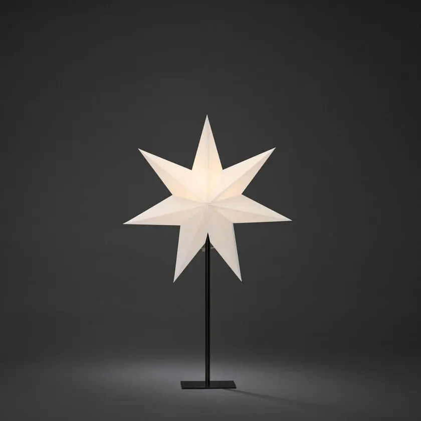 Estrella De Papel Ø40 Blanco De Konstsmide - La elegante estrella blanca reposa sobre un elegante soporte de metal negro y emite una luz suave y agradable.