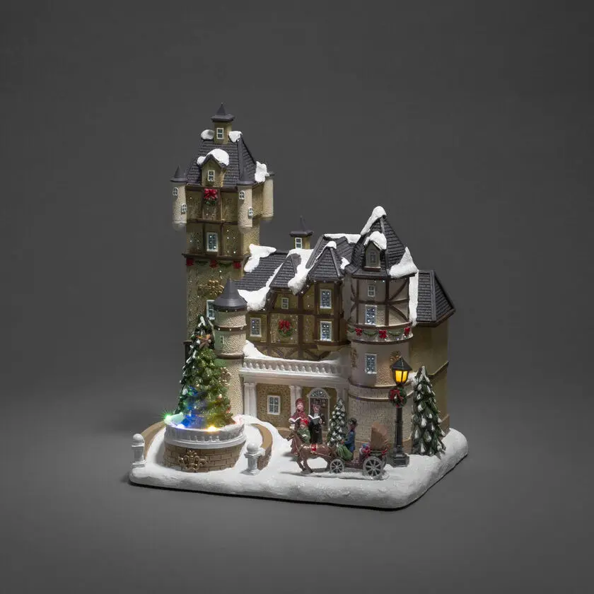 Casa De Fibra Óptica Multicolor De Konstsmide - Transforma tu hogar en un m&aacute;gico para&iacute;so invernal con esta decoraci&oacute;n navide&ntilde;a de fibra de vidrio con forma de casa cubierta de nieve.