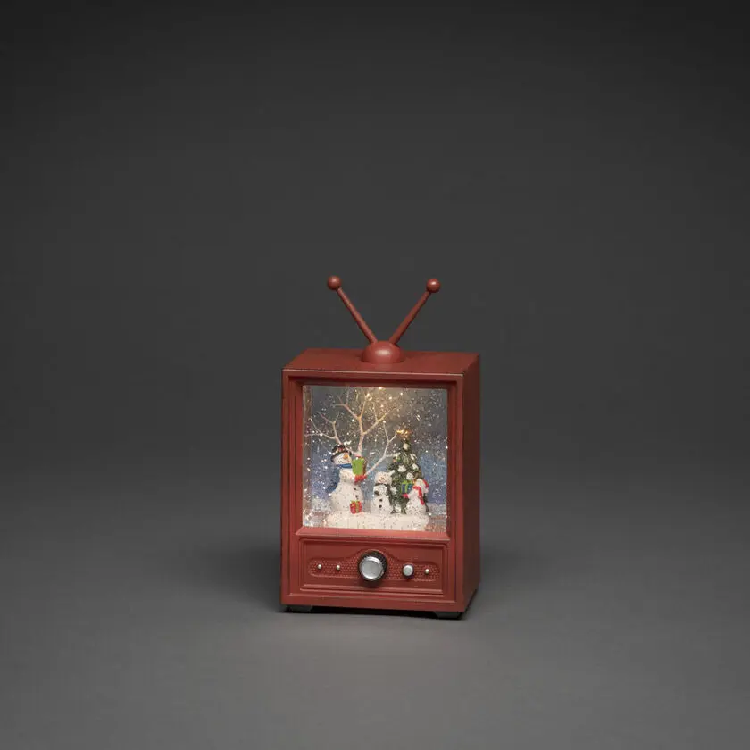 Linterna Rellena De Agua Con Forma De Televisor Marrón De Konstsmide - Esta linterna llena de agua con forma de televisor retro muestra un paisaje invernal con mu&ntilde;ecos de nieve y un &aacute;rbol de Navidad decorado.