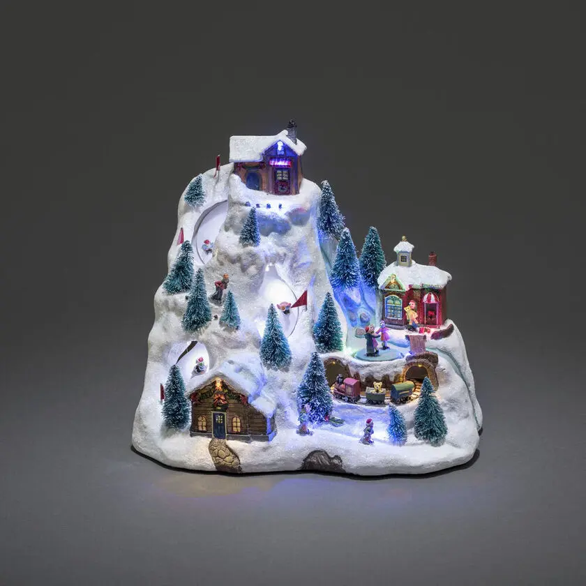 Decoración Navideña Mecánica Con Paisaje Montañoso 28cm Multicolor De Konstsmide - La escena de la monta&ntilde;a cubierta de nieve se ilumina con hermosas luces LED, detalles en movimiento y reproduce 8 canciones navide&ntilde;as cl&aacute;sicas.