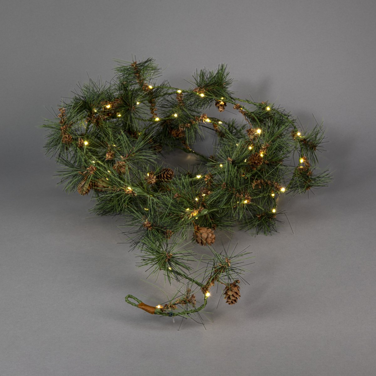 Guirnalda 6m Verde De Konstsmide - Esta guirnalda con agujas de pino artificiales y peque&ntilde;as pi&ntilde;as crea un ambiente invernal c&aacute;lido y acogedor.
