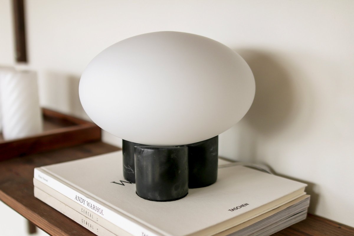 Mammut 18cm Negro lámpara de mesa De Globen Lighting - La base de la l&aacute;mpara est&aacute; equipada con una pantalla de cristal redonda, blanca mate y aplanada, de un tama&ntilde;o ligeramente sobredimensionado, que crea una expresi&oacute;n l&uacute;dica.