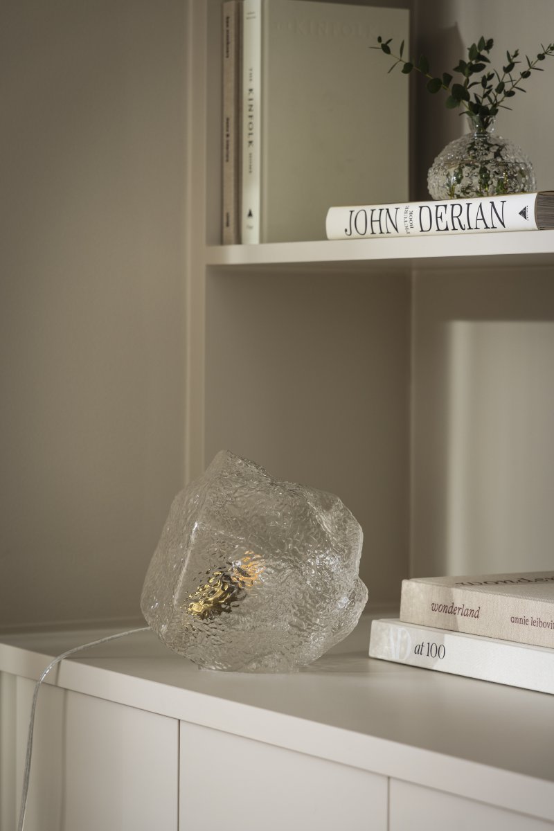 Valerie 22cm Transparente lámpara de mesa De Globen Lighting - El vidrio soplado a mano, con su superficie texturizada, captura la luz, creando un vibrante juego de luces.