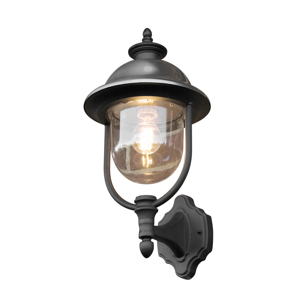 Parma Negro lámpara de exterior De Konstsmide - Con su robusta superficie negra y su pantalla de cristal transparente, emite una luz cálida y acogedora, creando un ambiente acogedor en la entrada o en la terraza.