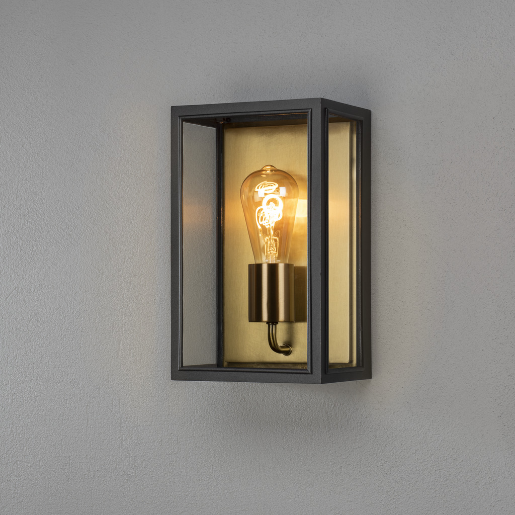 Carpi Latón lámpara de exterior De Konstsmide - Con su carcasa metálica rectangular y abierta y sus cálidos detalles de latón, crea un elegante juego de luz que le da a su entorno exterior un aspecto único.