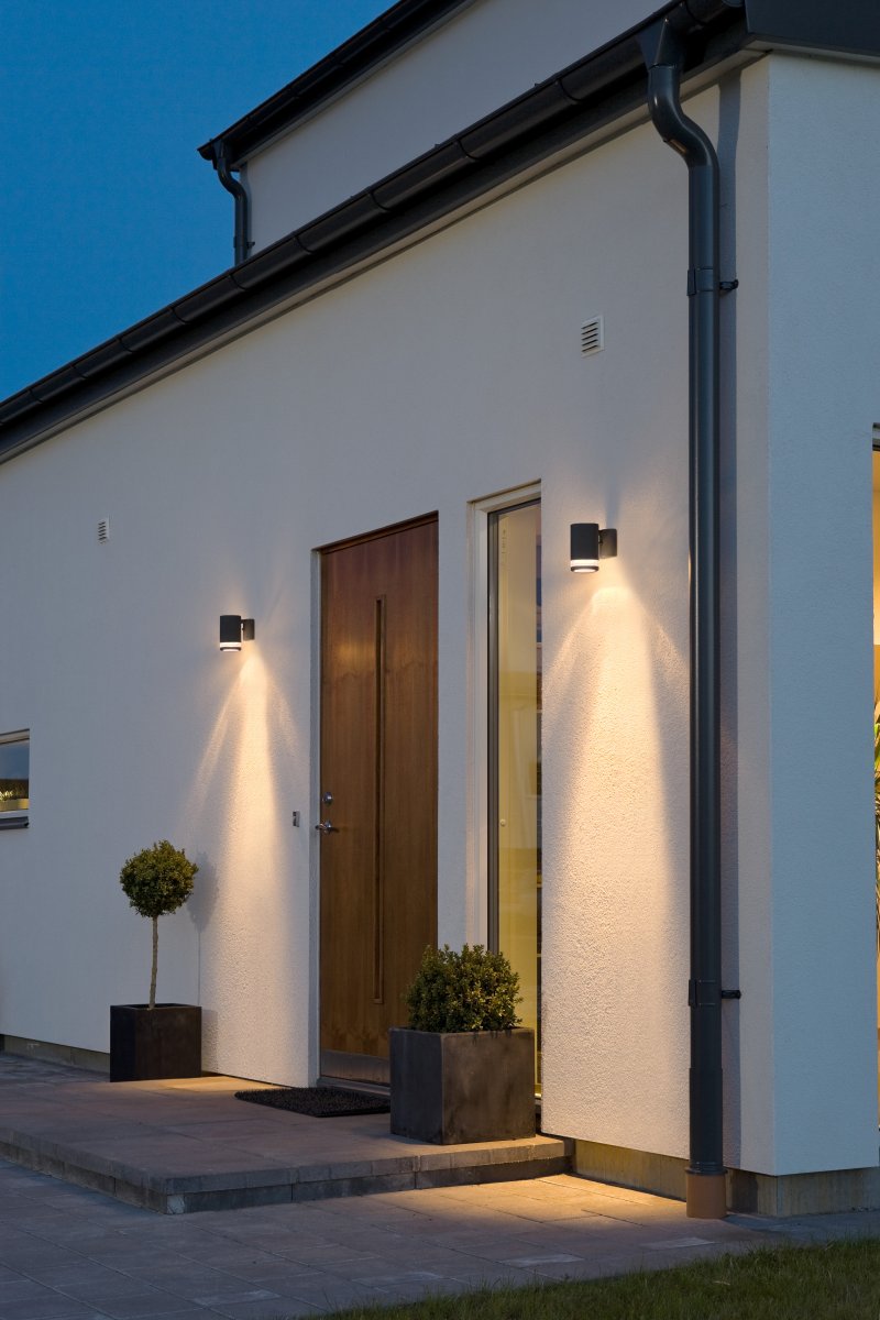 Modena Negro lámpara de exterior De Konstsmide - Gracias a su dise&ntilde;o atemporal, Modena se integra a la perfecci&oacute;n tanto en espacios modernos como cl&aacute;sicos y se convierte en un elemento decorativo incluso cuando est&aacute; apagada.