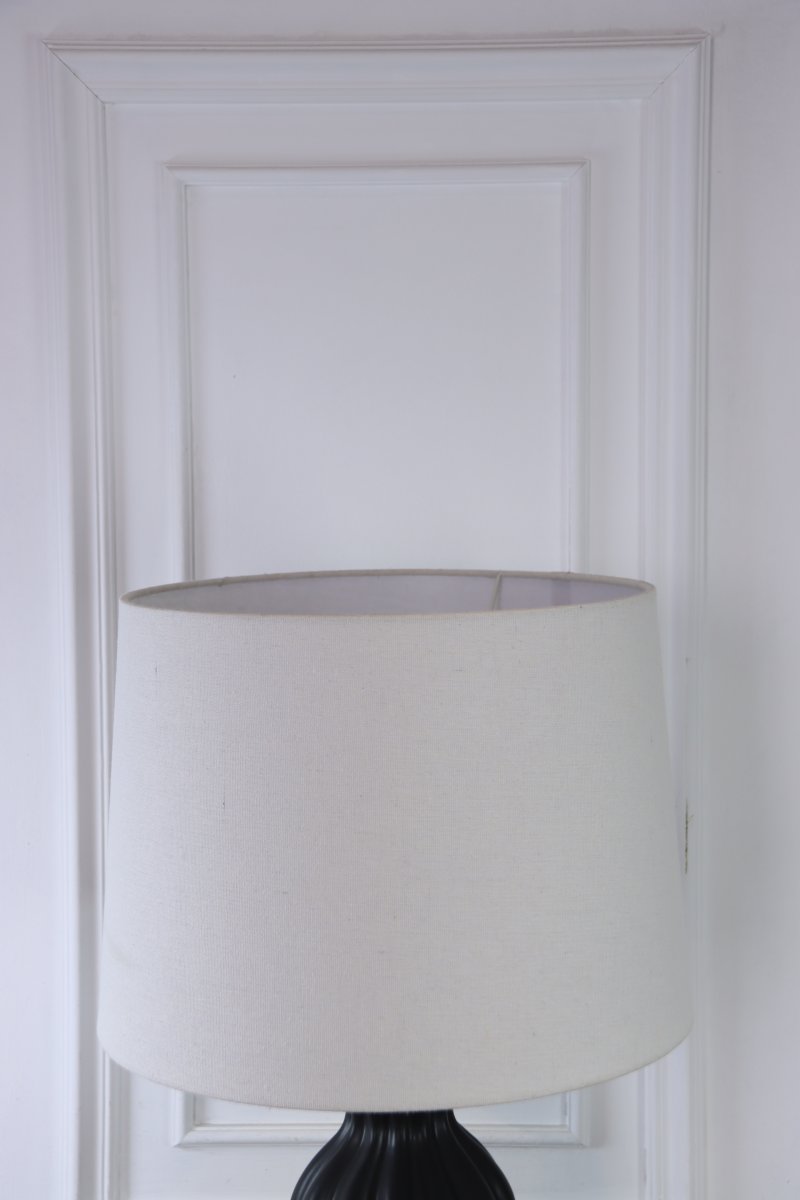 Amfora 67cm Negro lámpara de mesa De Lampan - Su base de cer&aacute;mica impresiona por su elegante silueta de l&iacute;neas suaves y una superficie lisa y negra, creando una atm&oacute;sfera armoniosa.