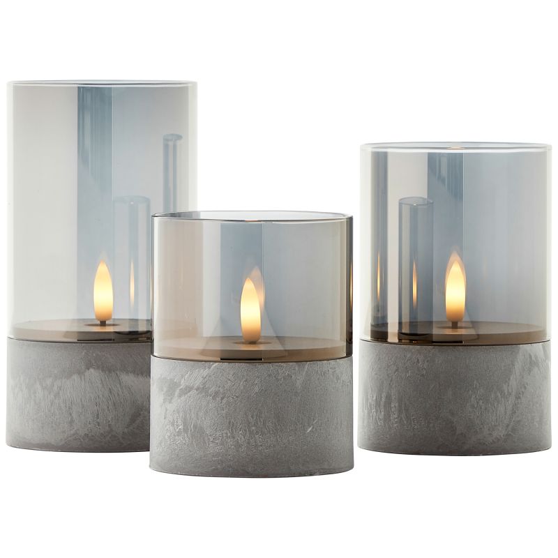Bougie Pack De 3 Gris/humo De Brilliant - El set incluye l&aacute;mparas de 10 cm, 12,5 cm y 15 cm de altura, todas con un di&aacute;metro de 8 cm, perfectas para una mesa, una estanter&iacute;a o el alf&eacute;izar de una ventana.